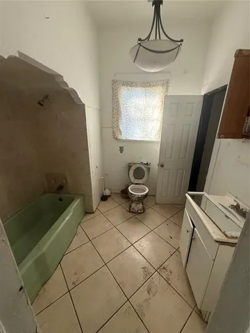 a kitchen with a sink a stove and cabinets