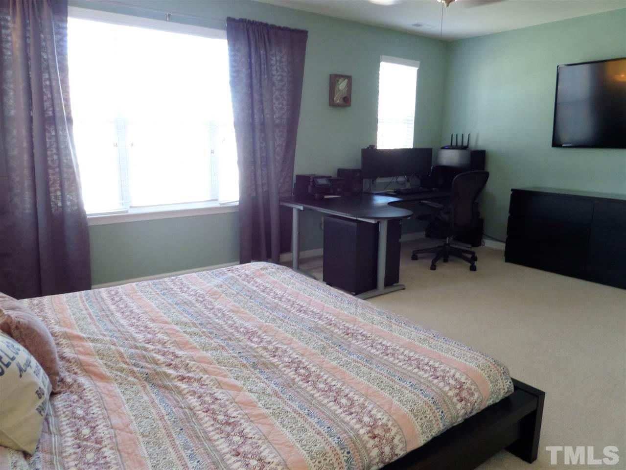 9813 Layla Avenue Raleigh, NC 27617 - Photo 14 of 23 a bedroom with a bed and a window