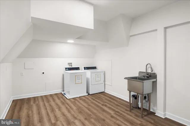 a kitchen with a sink cabinets and wooden floor