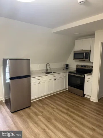 a kitchen with a white cabinets and white appliances