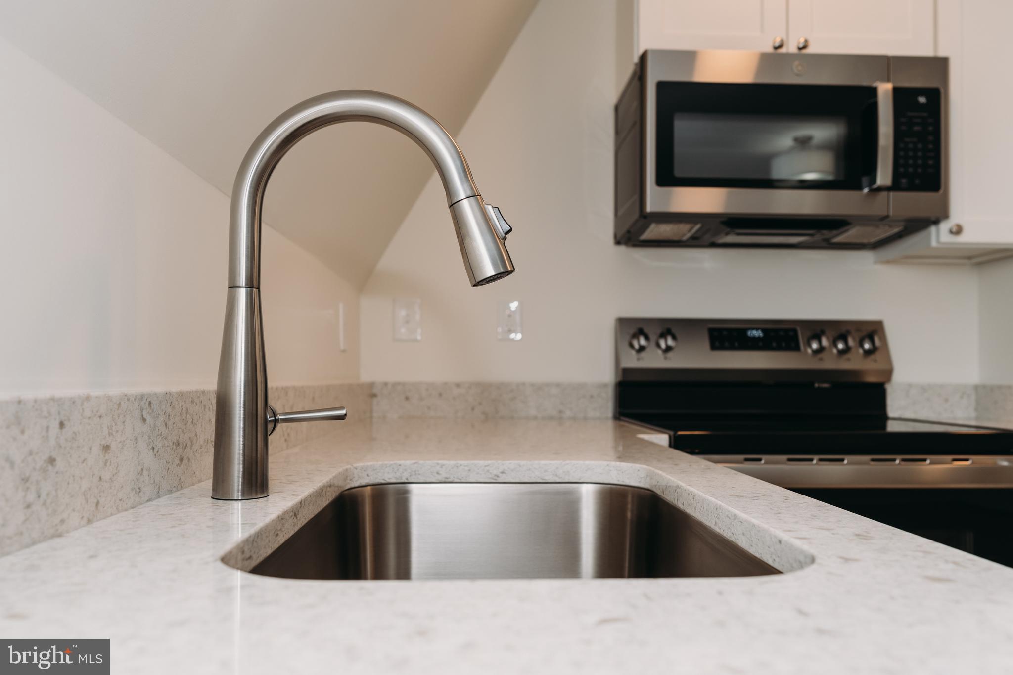 380 Broadview Avenue, Unit 2 Warrenton, VA 20186 - Photo 4 of 11 a kitchen with a sink and a microwave