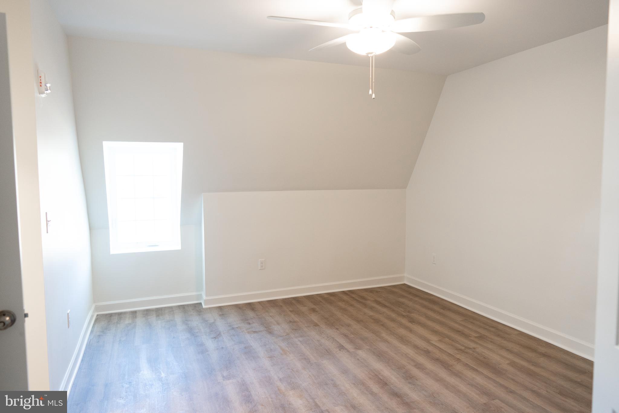 380 Broadview Avenue, Unit 2 Warrenton, VA 20186 - Photo 7 of 11 an empty room with wooden floor and windows