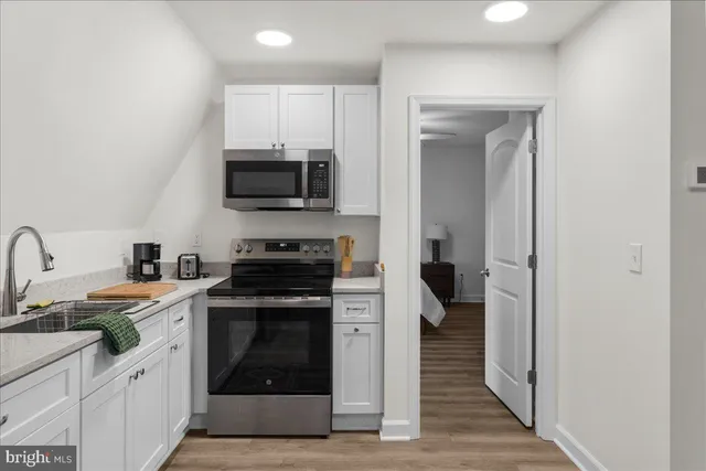 a kitchen with a sink stove and cabinets