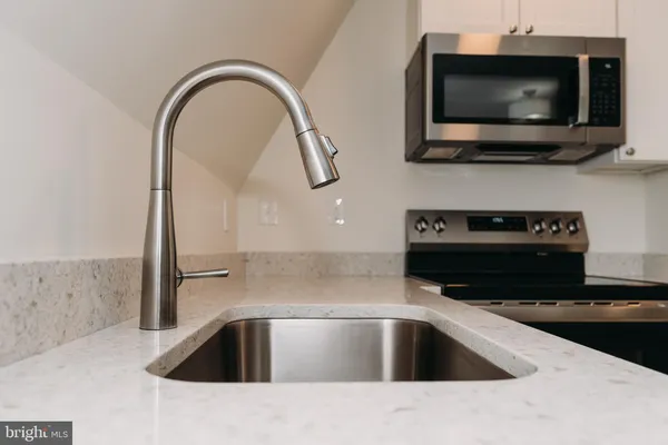 a kitchen with a sink and a microwave