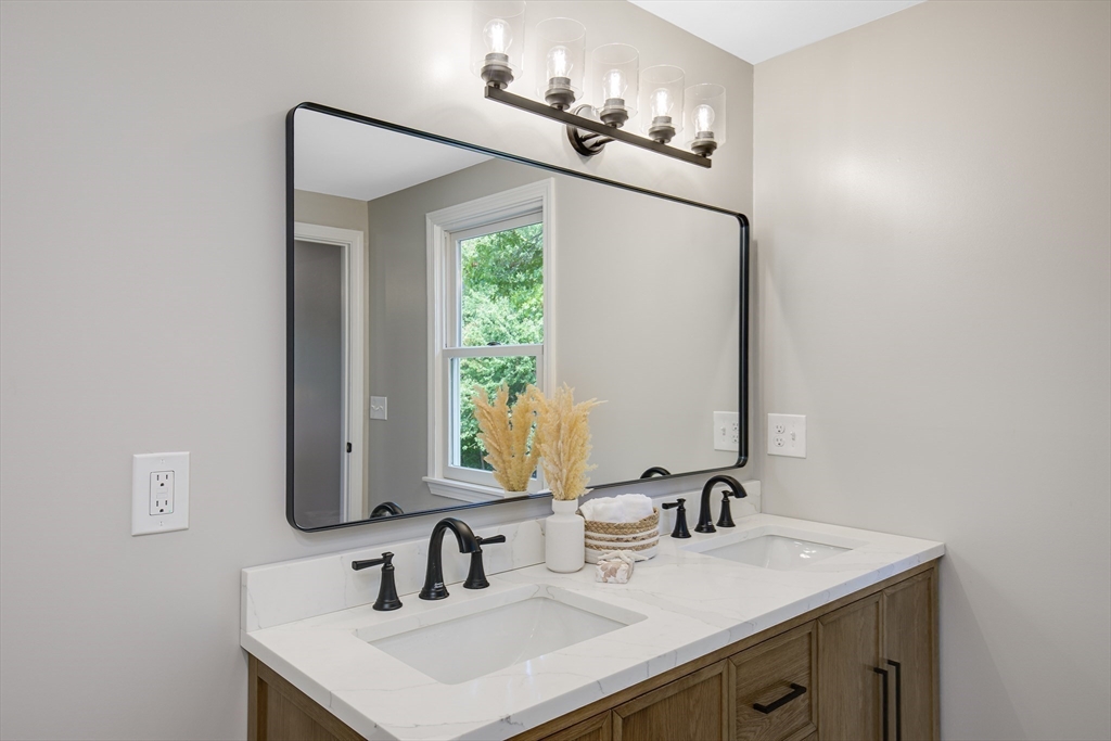 39 Middle Road, Unit A Newbury, MA 01951 - Photo 15 of 40 a bathroom with a sink and a mirror