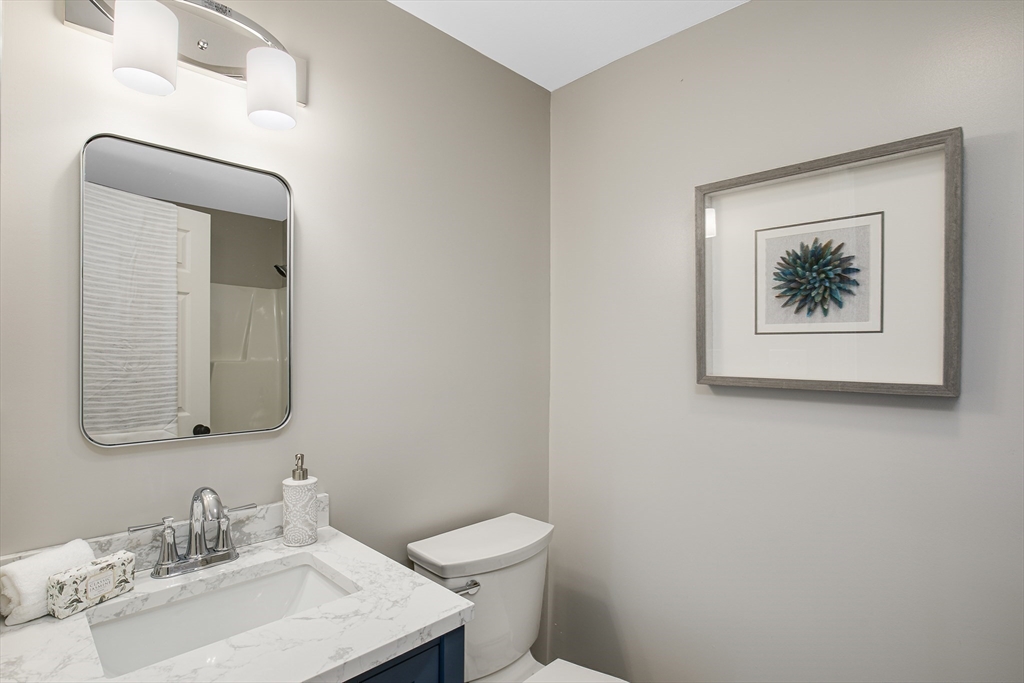 39 Middle Road, Unit A Newbury, MA 01951 - Photo 20 of 40 a bathroom with a toilet a sink and mirror
