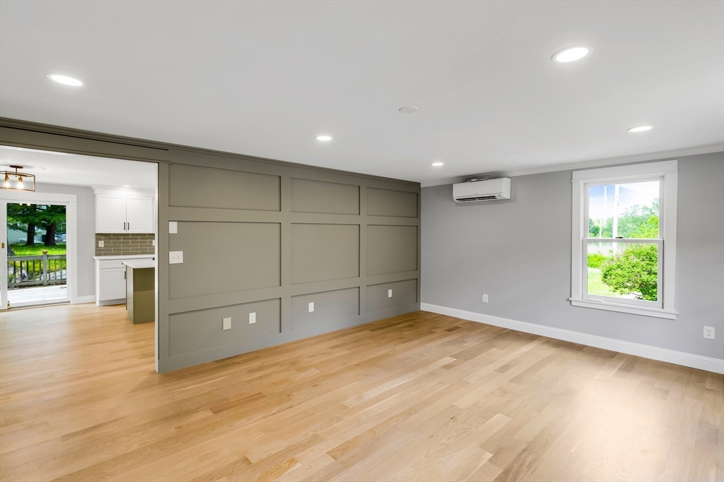 39 Middle Road, Unit A Newbury, MA 01951 - Photo 29 of 40 an empty room with wooden floor and windows