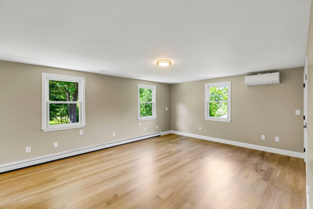 39 Middle Road, Unit A Newbury, MA 01951 - Photo 30 of 40 a view of an empty room with wooden floor and a window