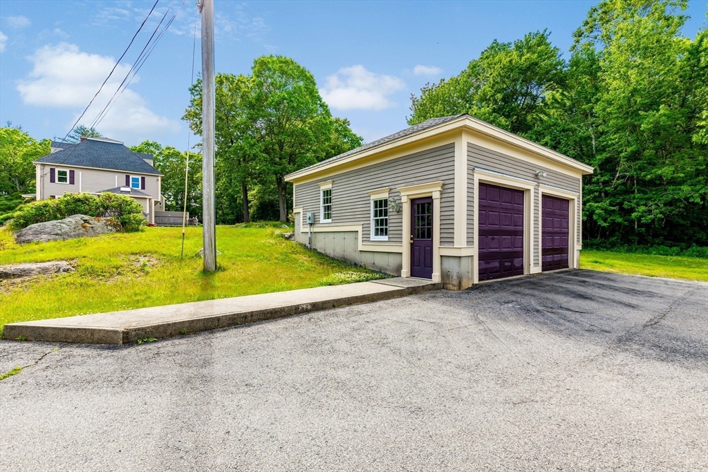 39 Middle Road, Unit A Newbury, MA 01951 - Photo 37 of 40 a view of a house with a backyard and a small yard