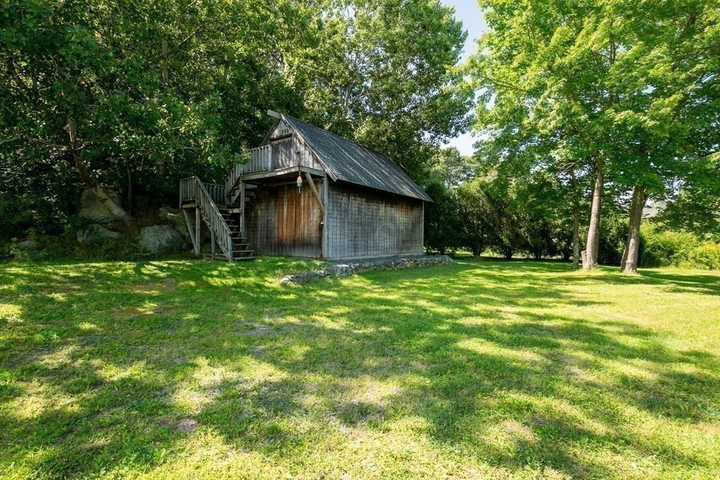 39 Middle Road, Unit A Newbury, MA 01951 - Photo 40 of 40 a backyard of a house with large trees and plants