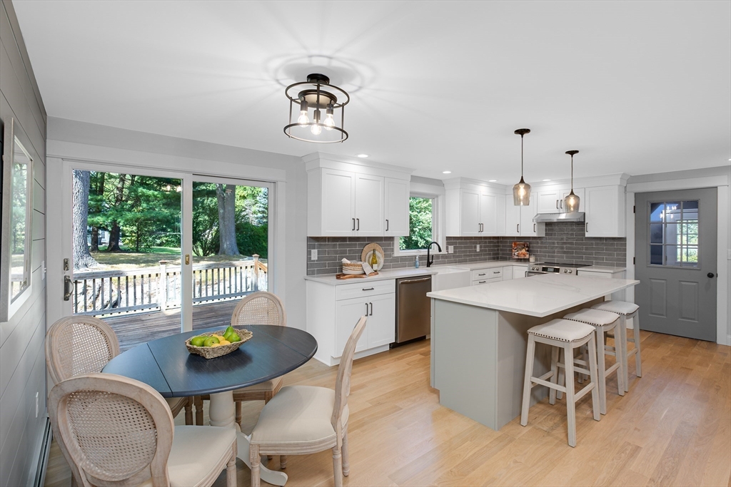 39 Middle Road, Unit A Newbury, MA 01951 - Photo 4 of 40 a kitchen with a dining table chairs and stove