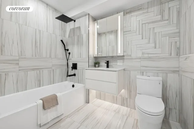 a bathroom with a sink a toilet and bathtub