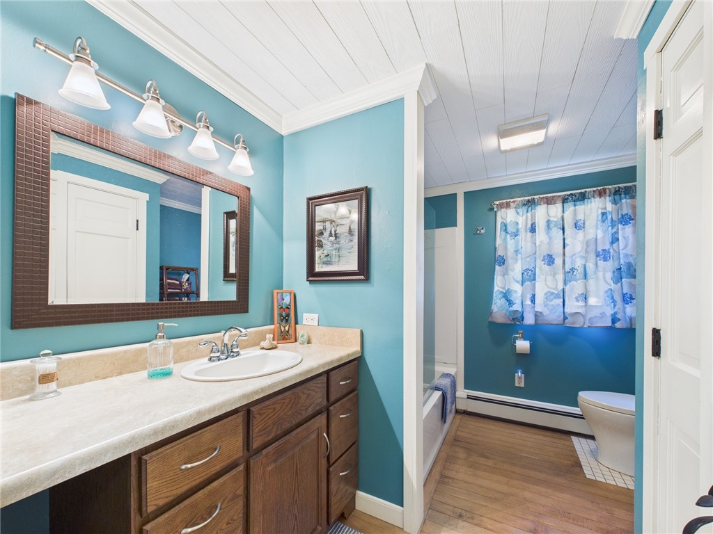 95 Mail Road Exeter, RI 02822 - Photo 18 of 33 The main bathroom off the hallway to the bedrooms, ONE OF 2 BATHROOMS in the home, features a SEAMLESS state-of-the art toilet, sink w/vanity, tub/shower w/ surround, & rock maple flooring! The 2ND is a LAVETTE off the primary bedroom.