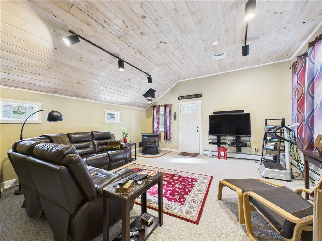 95 Mail Road Exeter, RI 02822 - Photo 25 of 33 Viewed from another angle, a glimpse of the PELLET STOVE (2022) to the far left...this room also has a built-in ironing board, conveniently located near the laundry room.