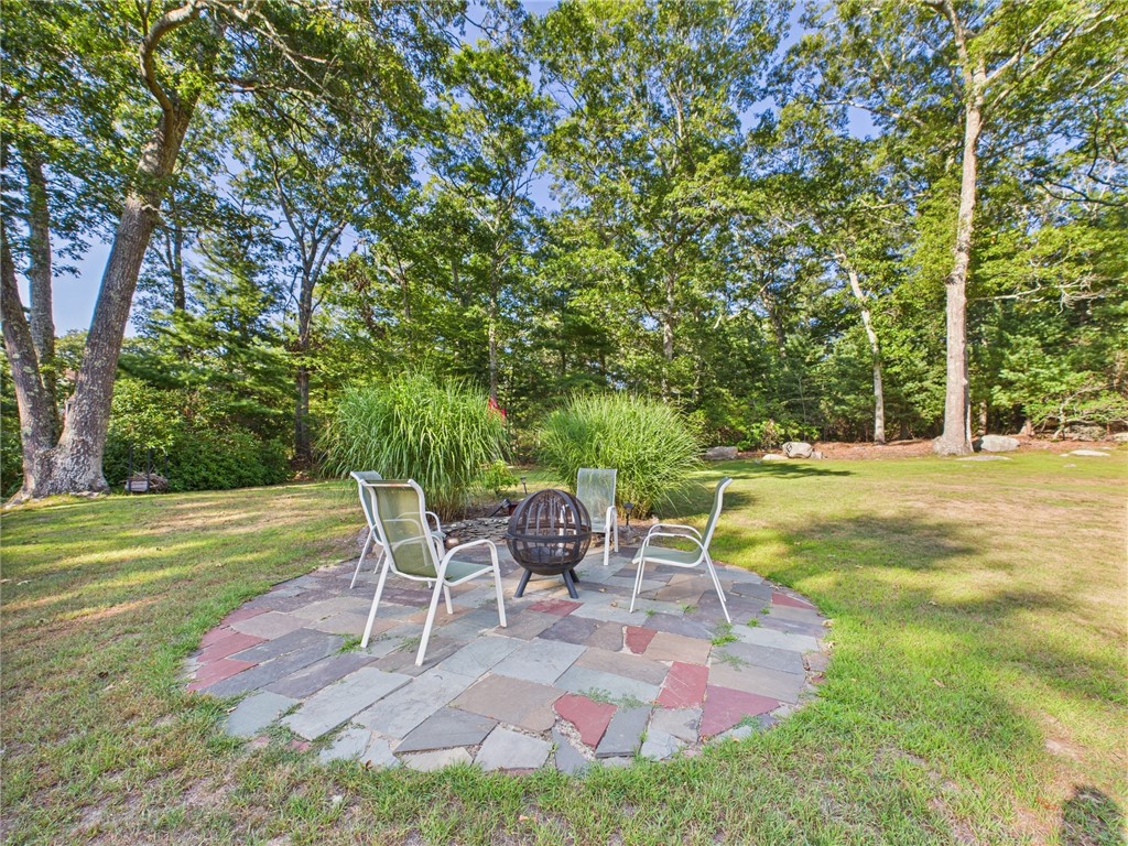 95 Mail Road Exeter, RI 02822 - Photo 29 of 33 One of two patios; the other one, nestled between the porch and family room holds the grill and outdoor table and chairs. Pictured is a cozy escape around the firepit.