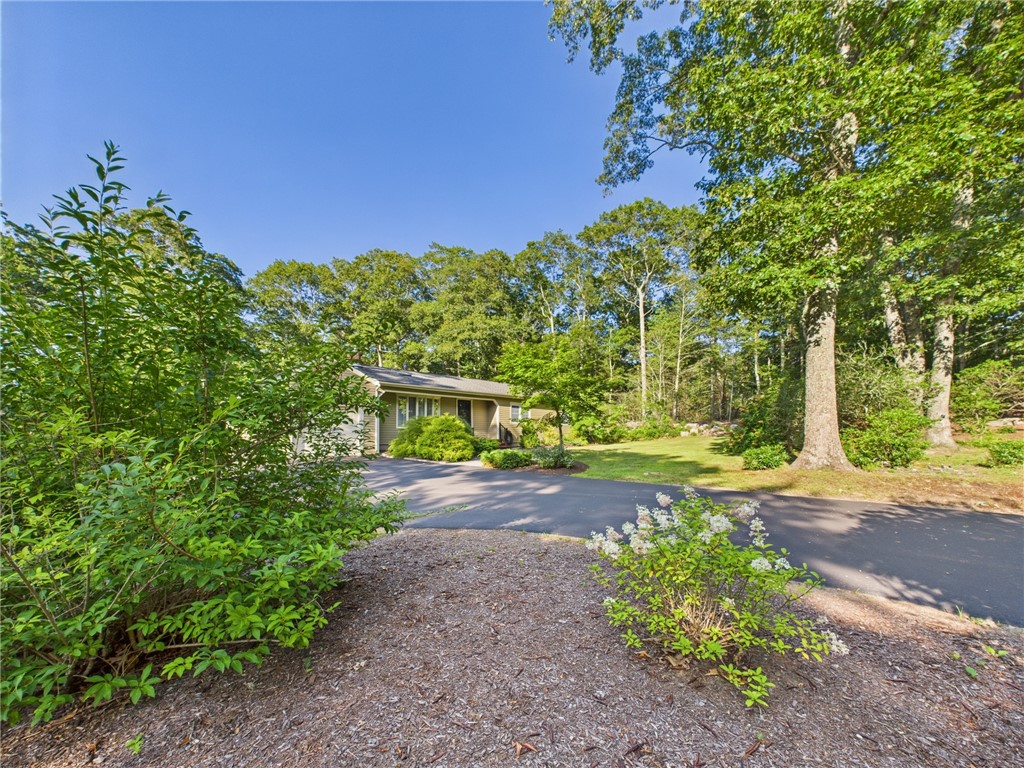 95 Mail Road Exeter, RI 02822 - Photo 3 of 33 View of driveway accessing the house and showing the curve to the left which provides additional driveway space to an alternate (shared) exit to Mail Rd.