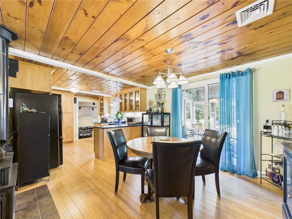 95 Mail Road Exeter, RI 02822 - Photo 9 of 33 This home has an open flow and is deceiving in size from a drive by. This angle shows the flow from the dining room to the stunning kitchen and beyond to a grand sunken family room (note open doorway). The family room is tucked behind the garage!