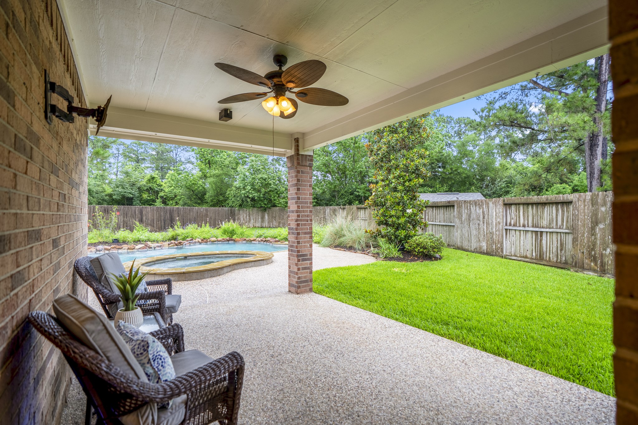 6311 Sparrows Glen Lane Spring, TX 77379 - Photo 31 of 50 Stepping outside, the covered patio sets the tone for the backyard retreat, offering a shaded place to unwind with the pool + spa just steps away.