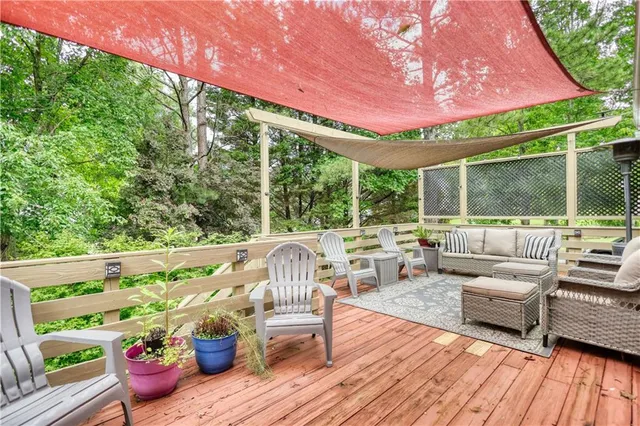 a view of a patio with couches chairs and wooden floor