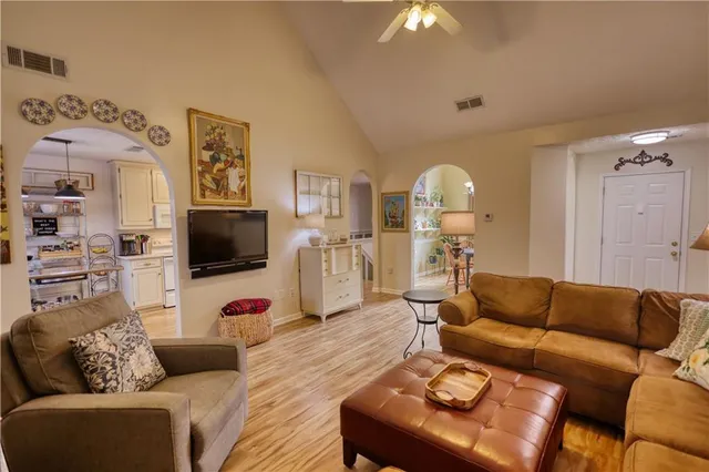 a kitchen with stainless steel appliances granite countertop a stove refrigerator and cabinets