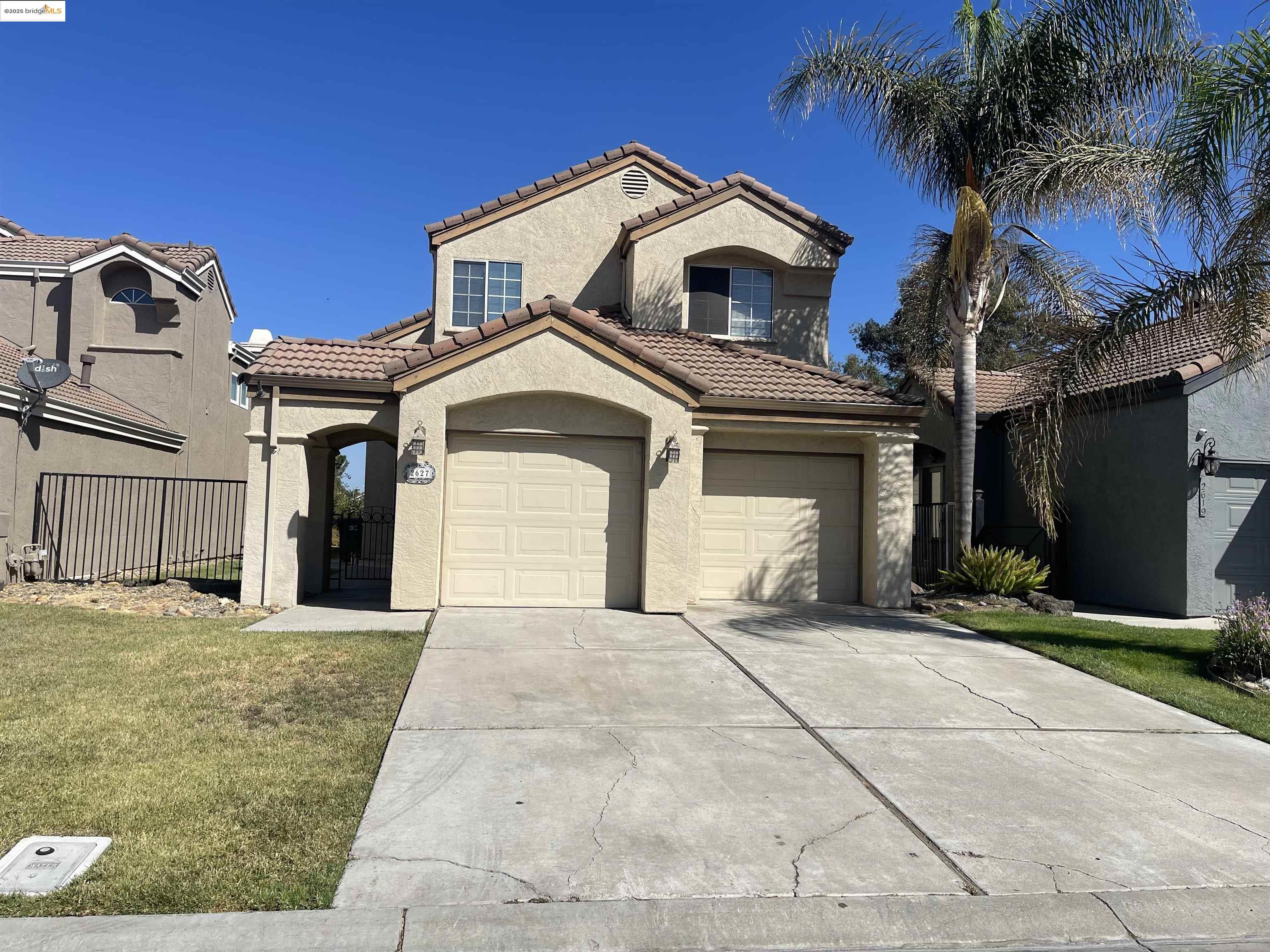 a front view of a house with yard and tress