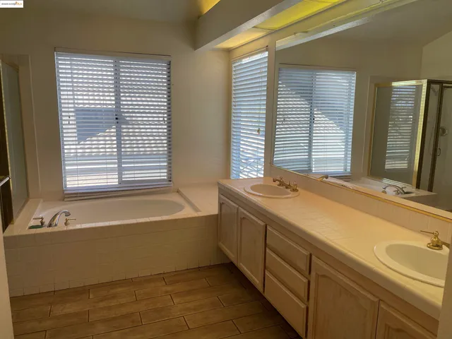 a spacious bathroom with a bathtub and a sink