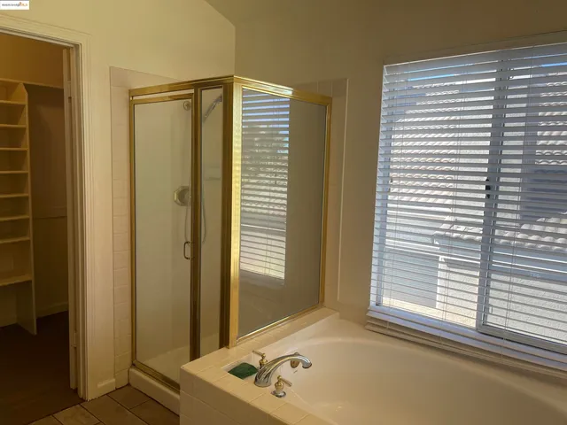 a bathroom with a bathtub and a window