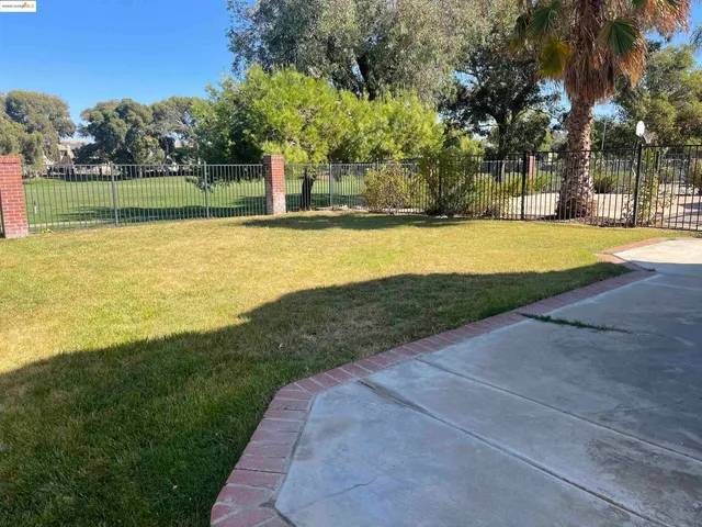 a view of a swimming pool with a yard