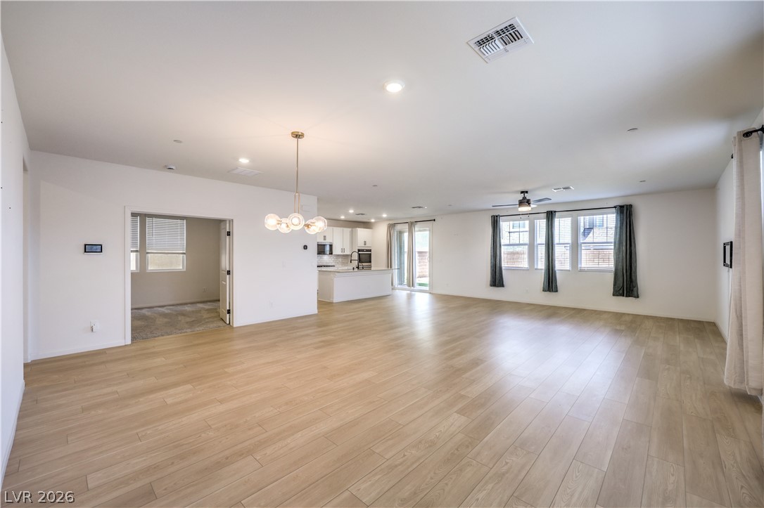 3782 Alla Rocca Avenue Henderson, NV 89044 - Photo 6 of 55 This expansive open-concept area features light wood flooring and abundant natural light.