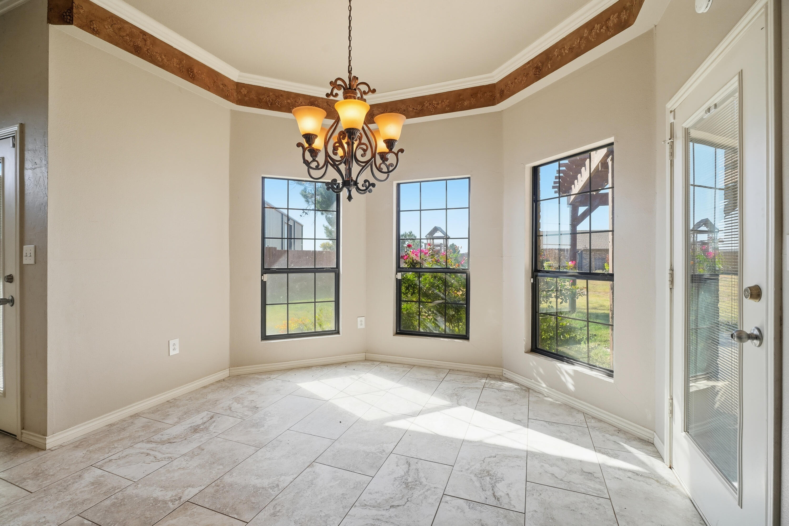 5601 County Road 7920 Lubbock, TX 79424 - Photo 13 of 68 a view of a big room with windows and chandelier