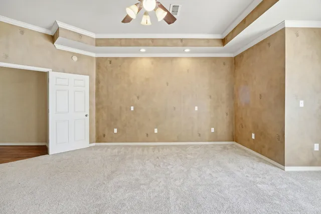 a living room with furniture a fireplace and a chandelier