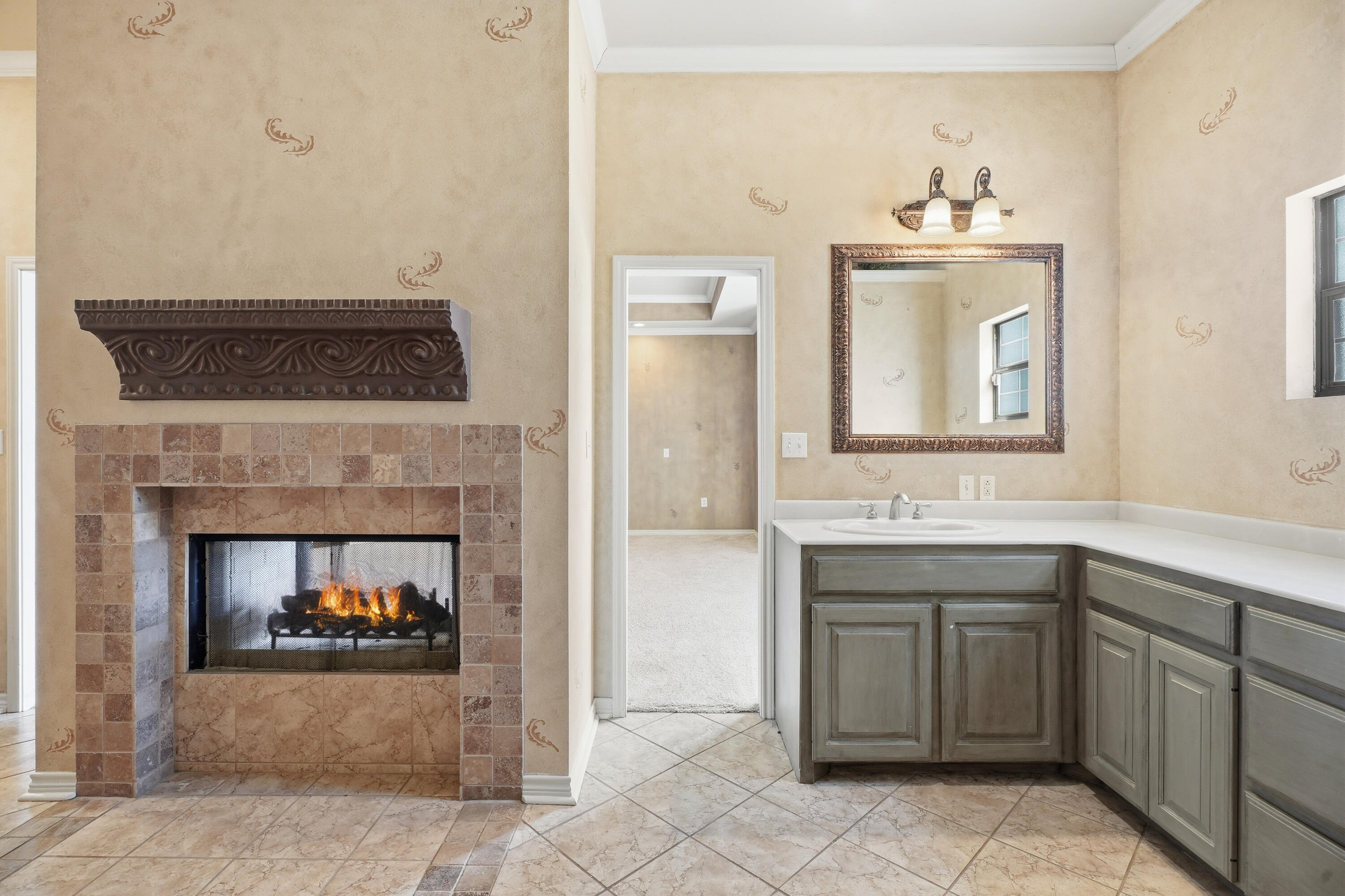 5601 County Road 7920 Lubbock, TX 79424 - Photo 26 of 68 a kitchen with a sink and a fireplace