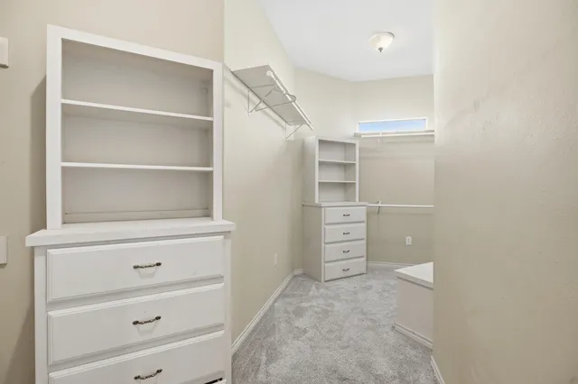 a view of an empty room and a ceiling fan