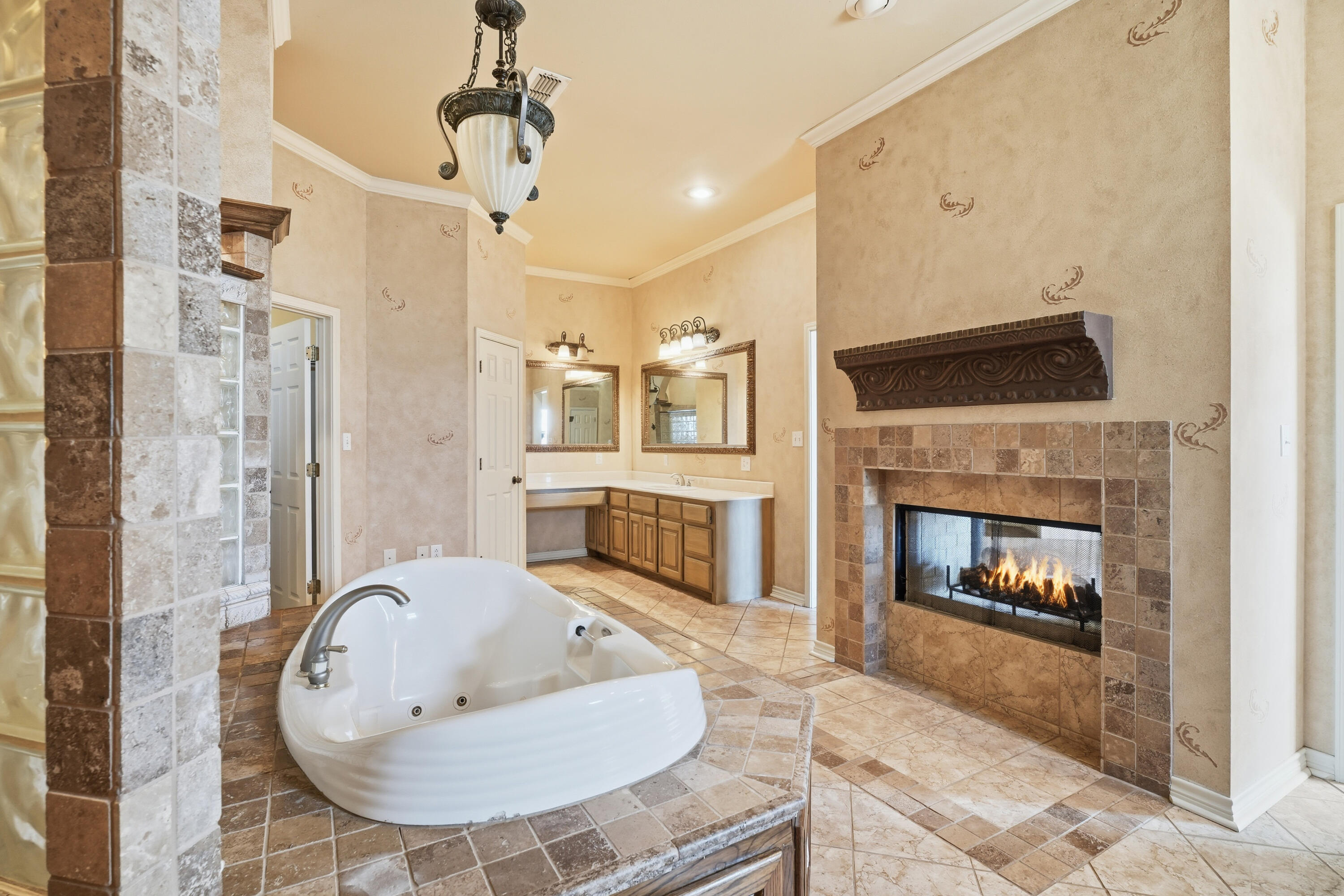 5601 County Road 7920 Lubbock, TX 79424 - Photo 29 of 68 a living room with furniture a fireplace and a chandelier