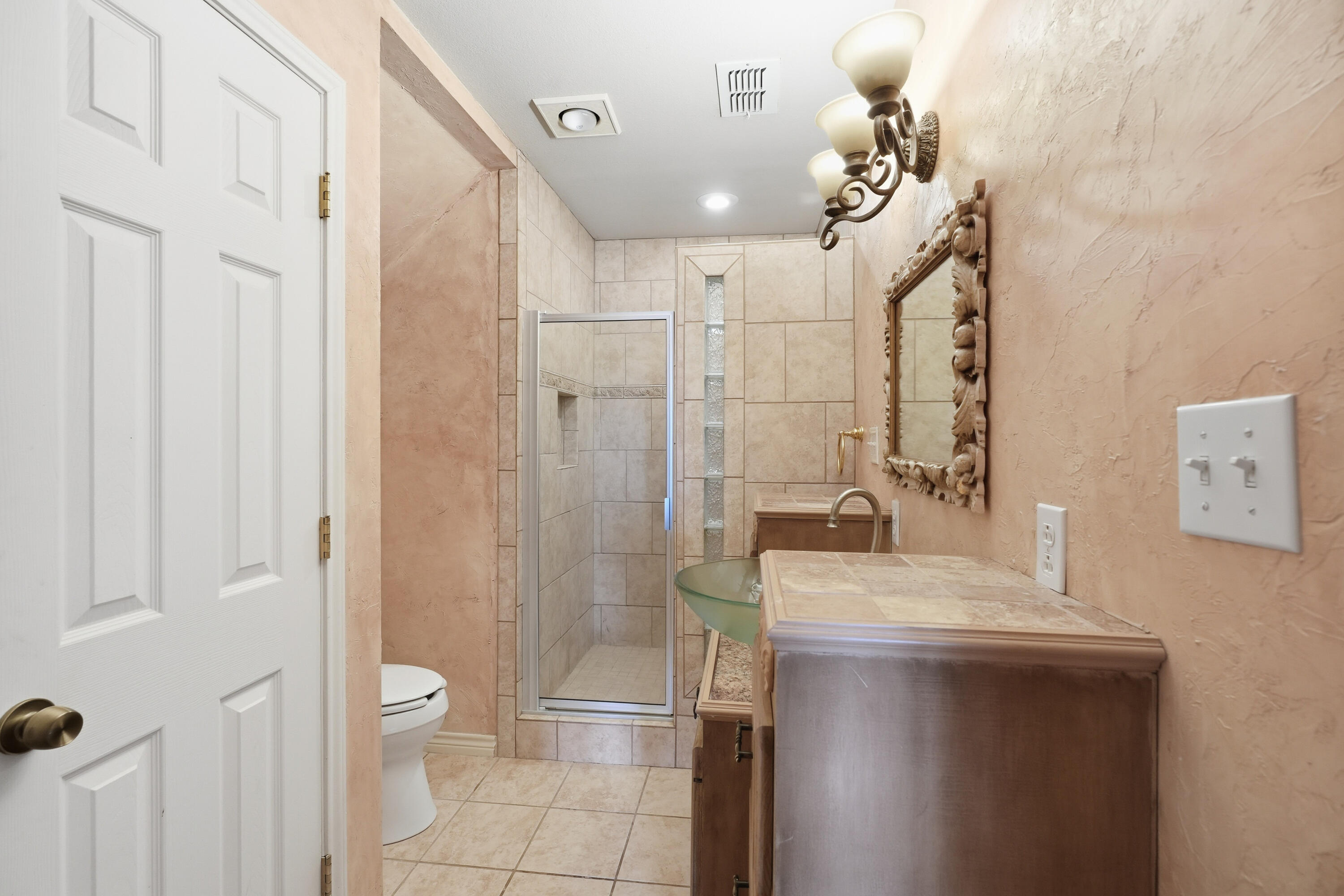 5601 County Road 7920 Lubbock, TX 79424 - Photo 33 of 68 a bathroom with a sink a toilet and shower