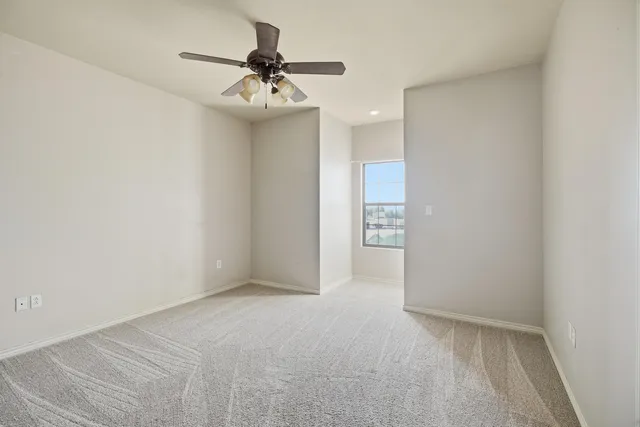 a view of a big room with closet and windows