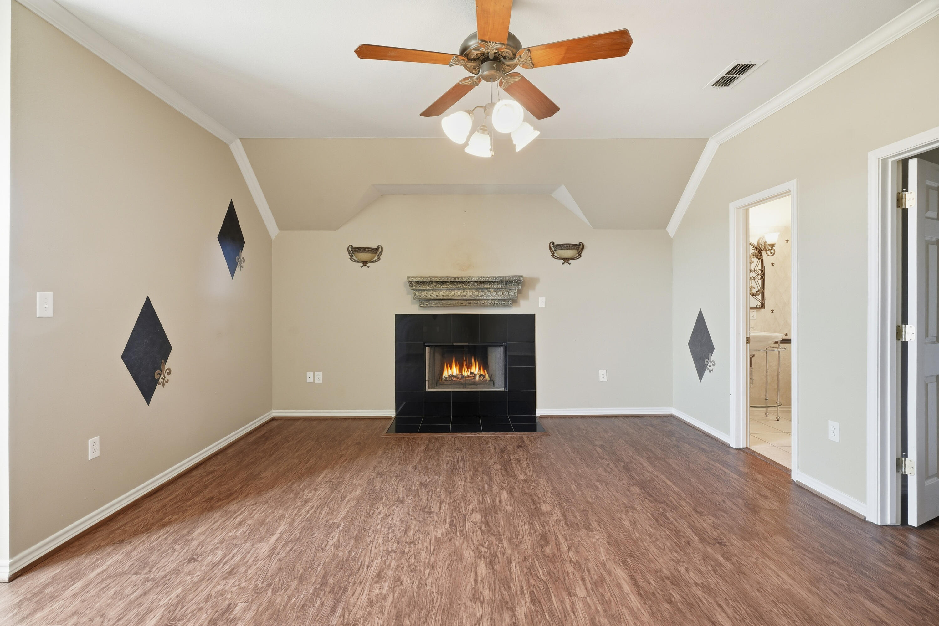 5601 County Road 7920 Lubbock, TX 79424 - Photo 40 of 68 a view of an empty room with a fireplace and a chandelier fan