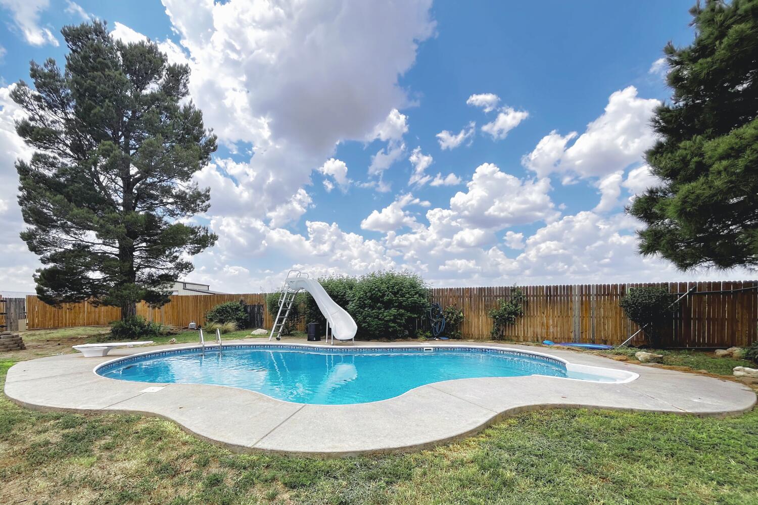 5601 County Road 7920 Lubbock, TX 79424 - Photo 50 of 68 a view of a swimming pool with a yard