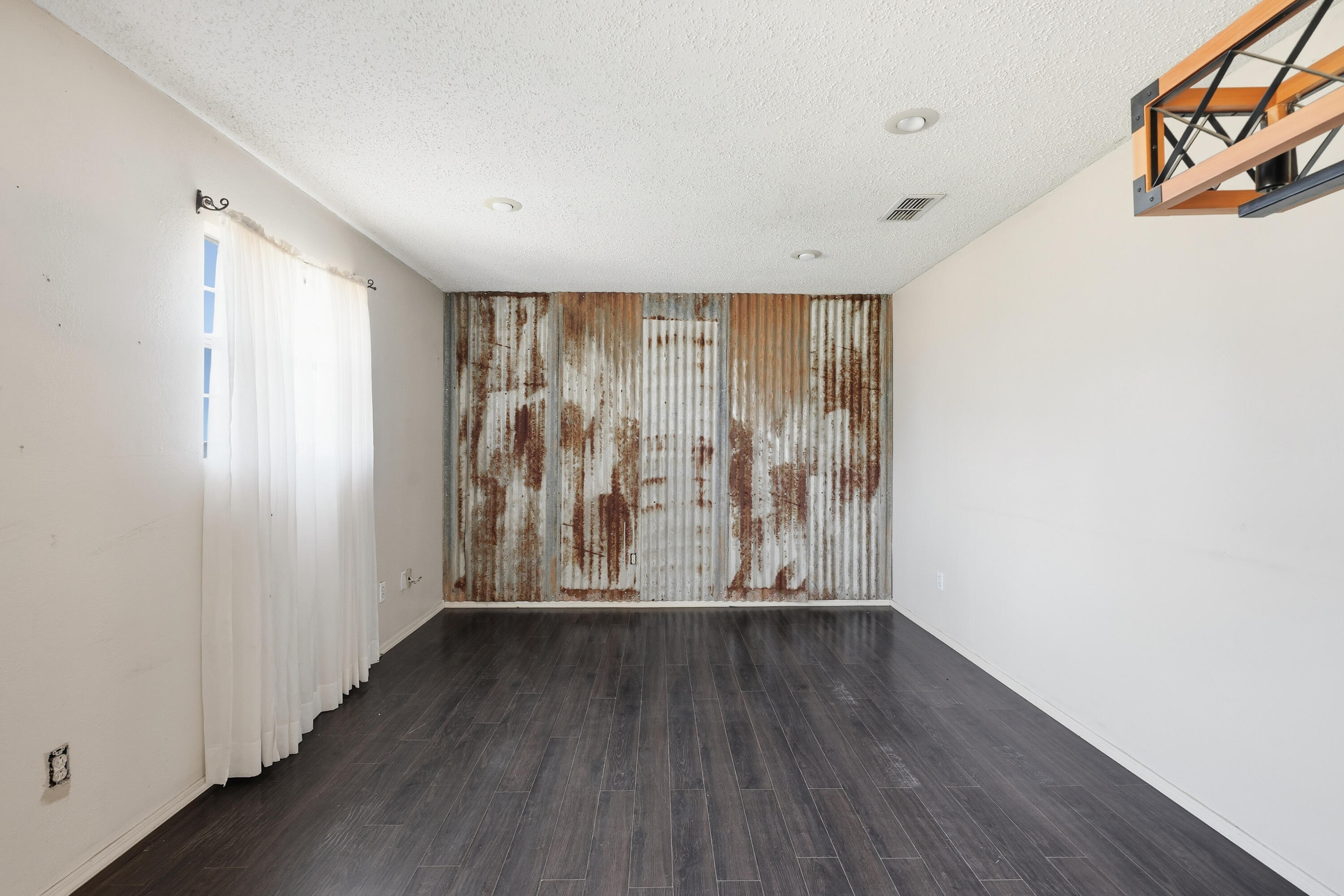 5601 County Road 7920 Lubbock, TX 79424 - Photo 53 of 68 an empty room with wooden floor and windows