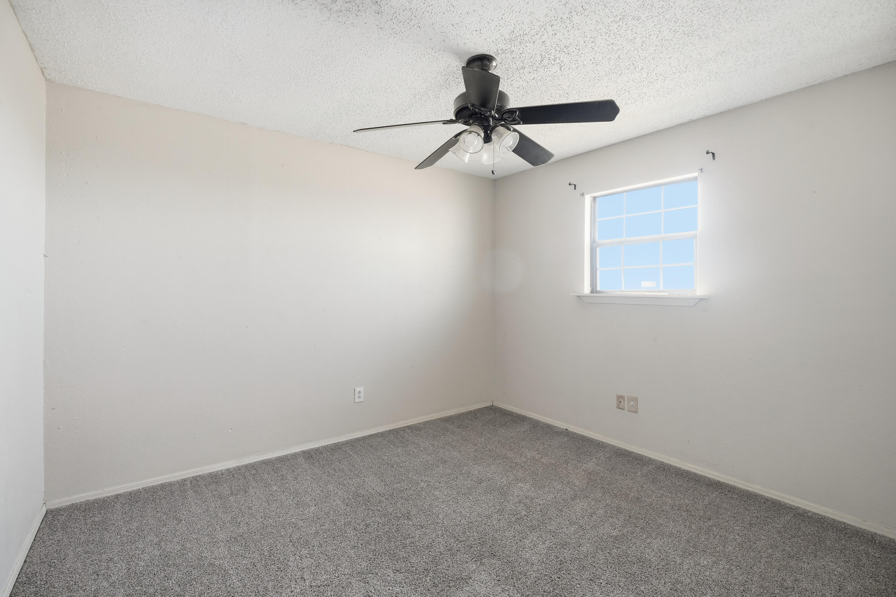 5601 County Road 7920 Lubbock, TX 79424 - Photo 56 of 68 an empty room with a window and a fan