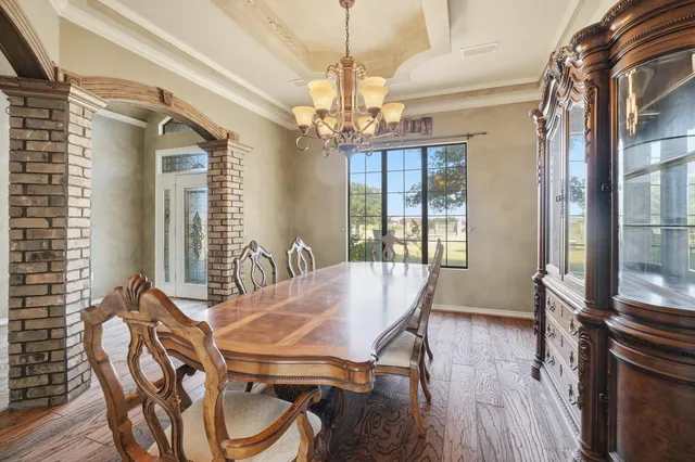 a view of an empty room with a fireplace and a fan