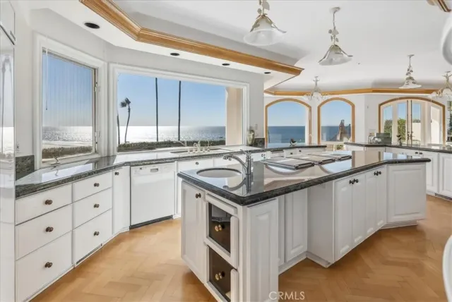 a living room with furniture a chandelier and a flat screen tv