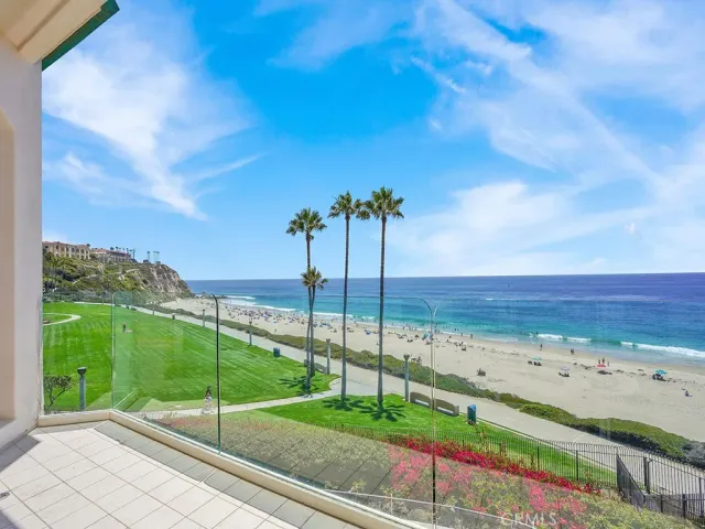 a view of swimming pool with a couches and table under an umbrella