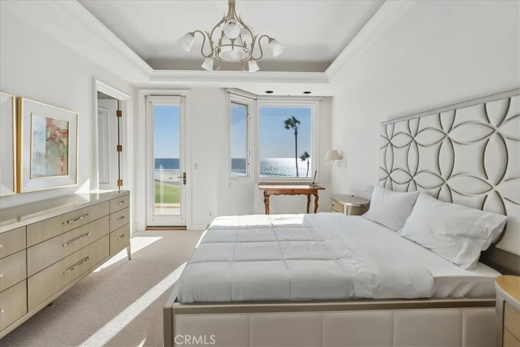 21 Ritz Cove Drive Dana Point, CA 92629 - Photo 42 of 72 a bedroom with a large bed and a chandelier