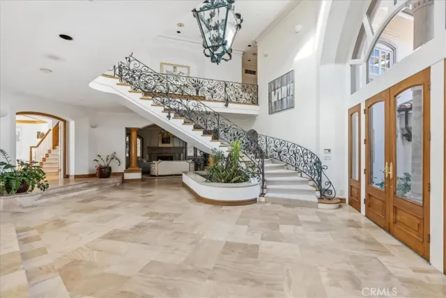 a very nice looking room with a large window and potted plants