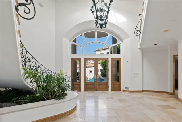 a view of a dining room with furniture a chandelier and wooden floor