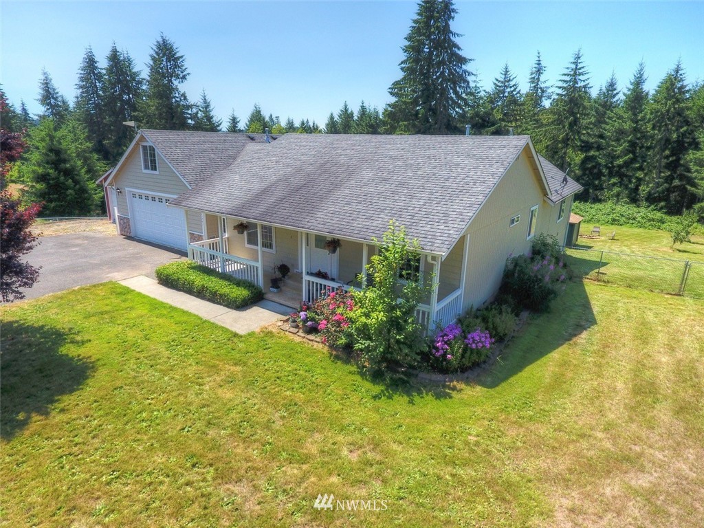 21741 Michigan Hill Road Southwest Rochester, WA 98579 - Photo 1 of 27 a view of a house with garden