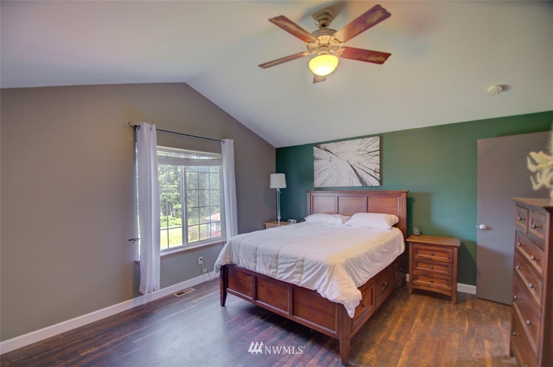 21741 Michigan Hill Road Southwest Rochester, WA 98579 - Photo 12 of 27 a bed sitting in a bedroom next to a window
