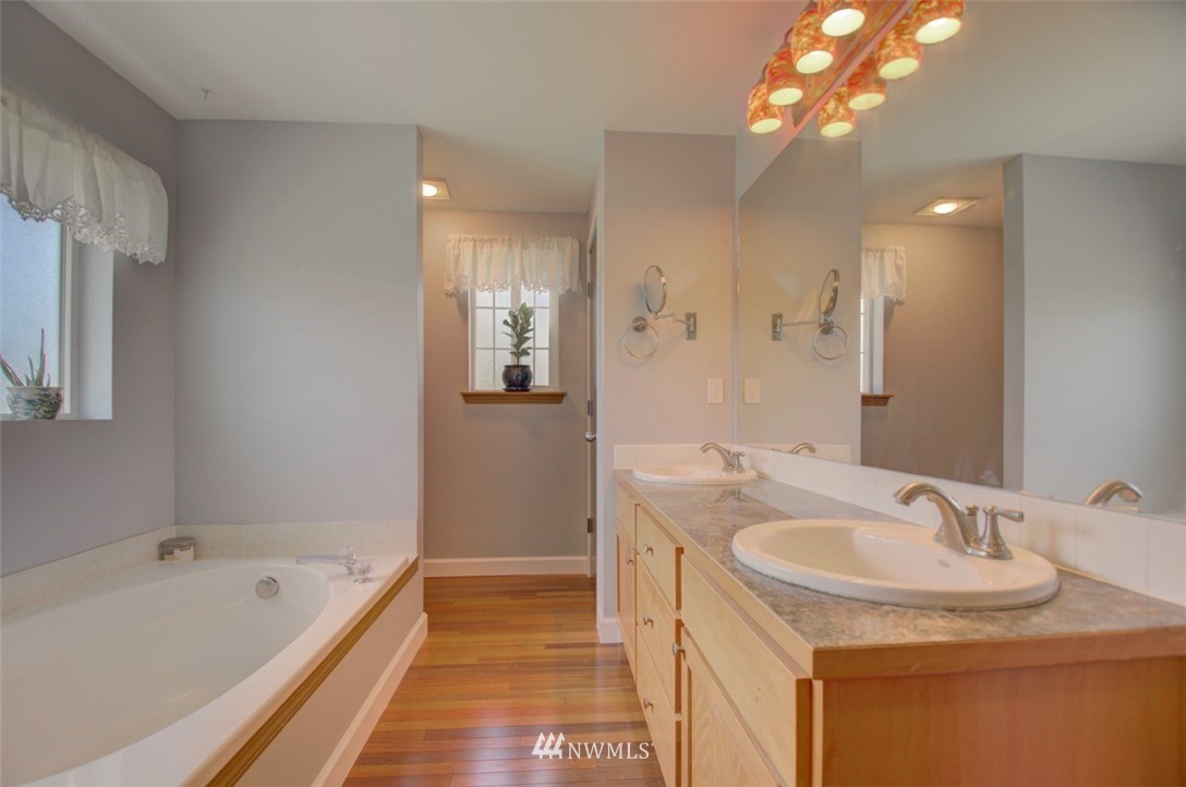 21741 Michigan Hill Road Southwest Rochester, WA 98579 - Photo 13 of 27 a bathroom with a tub sink and mirror