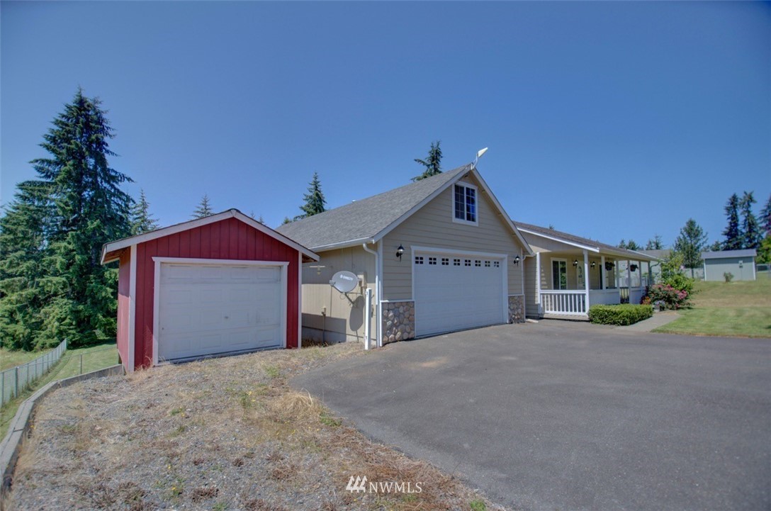 21741 Michigan Hill Road Southwest Rochester, WA 98579 - Photo 22 of 27 a view of a house with a yard and garage